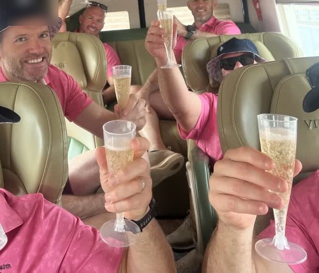 A group of friends raising champagne glasses in a limousine bus